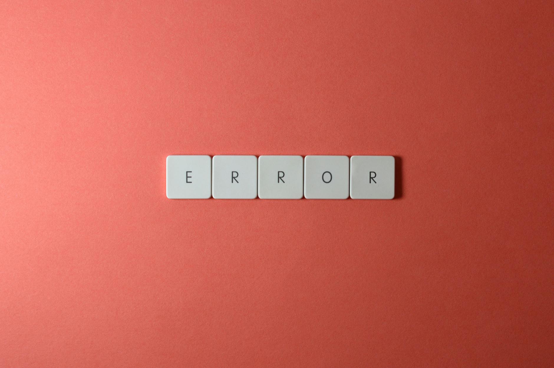 White letter tiles spelling 'ERROR' on a red backdrop, offering a minimalist design concept.